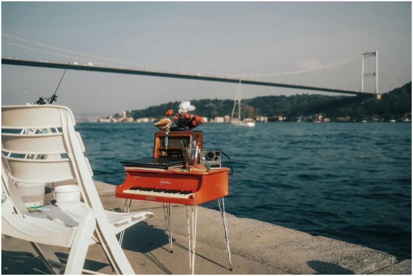 Red mini piano with decor by Bosphorus bridge at s