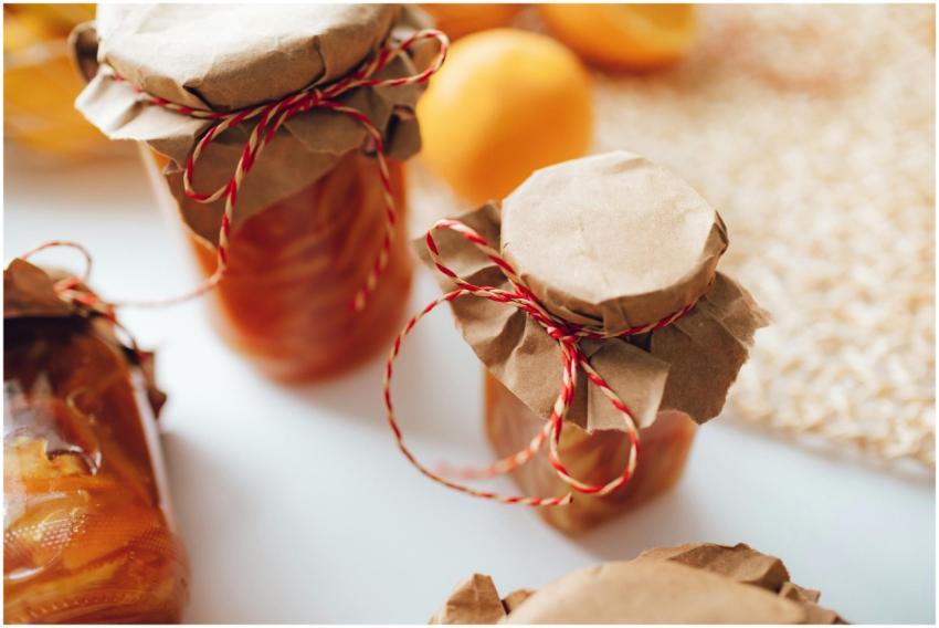 A close-up image of homemade preserves in jars wra