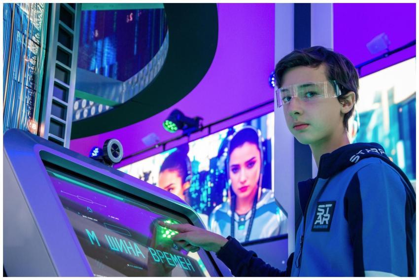 Teen boy in a digital room interacting with a futu