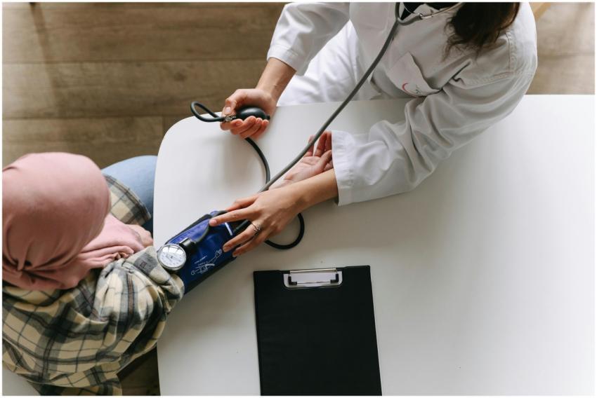 A medical practitioner checks a patient's blood pr
