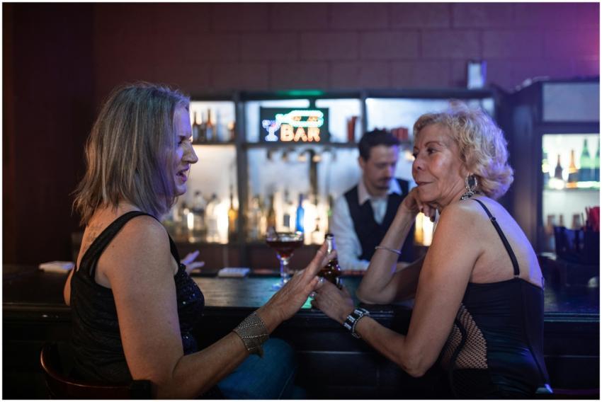 Two women enjoying conversations and cocktails at