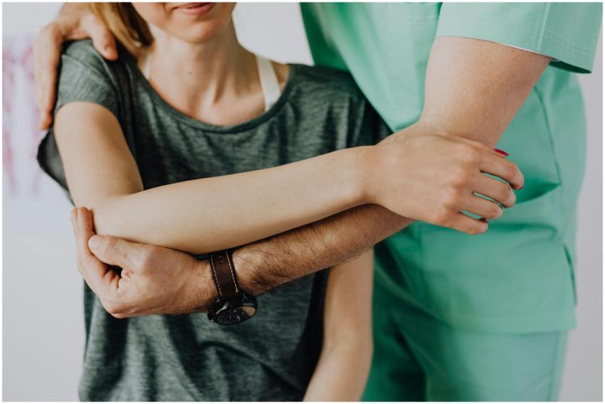 Professional therapist aids in arm rehabilitation