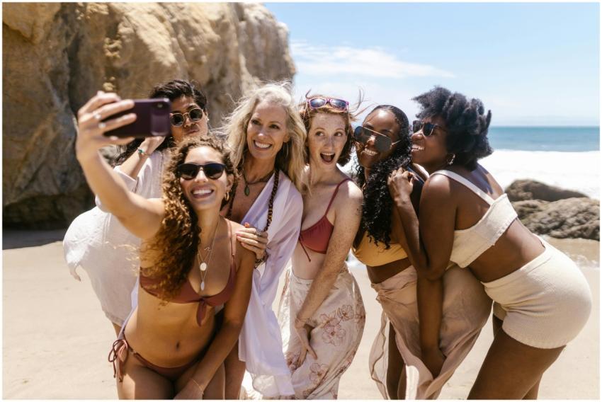 A group of diverse women smiling and taking a self