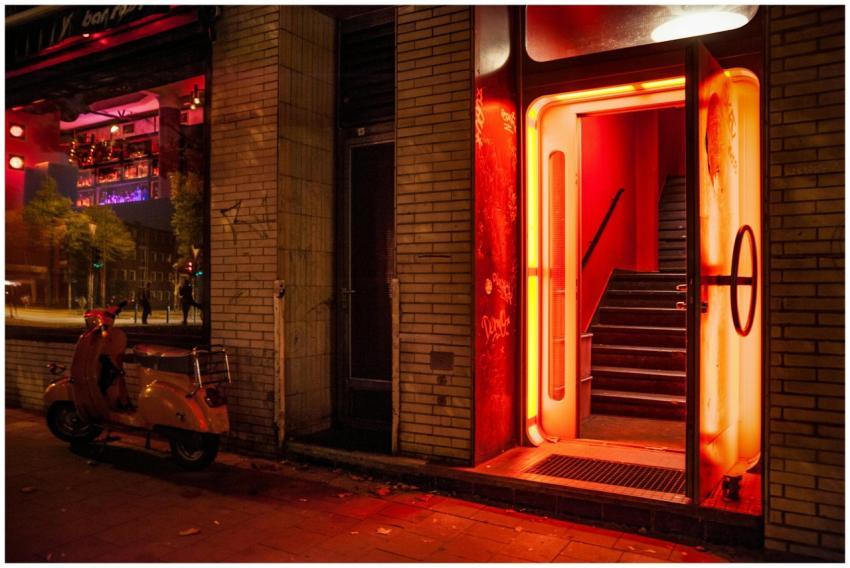 Illuminated entrance of a nightclub with neon red