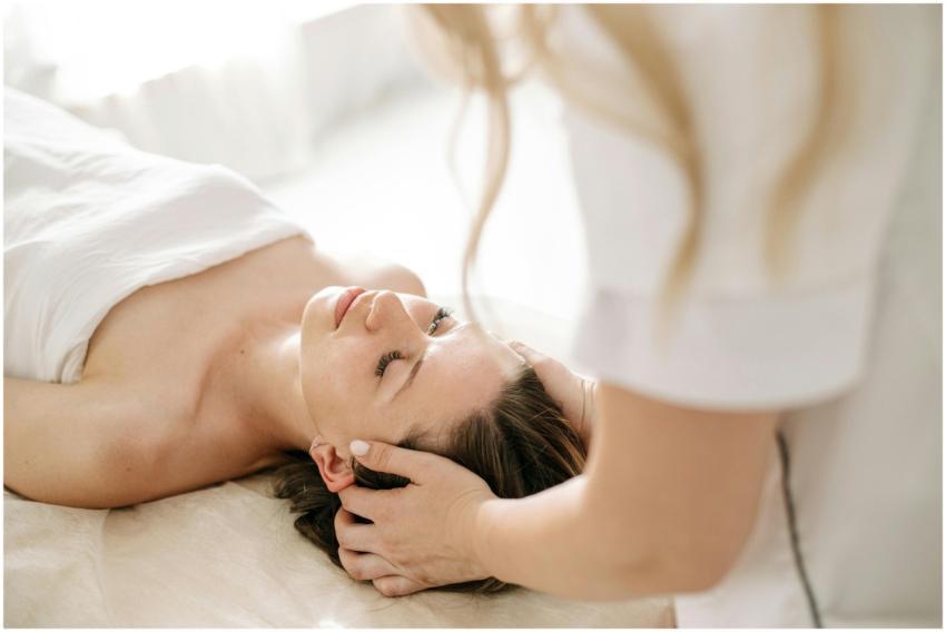 A woman receiving a calming head massage at a spa,