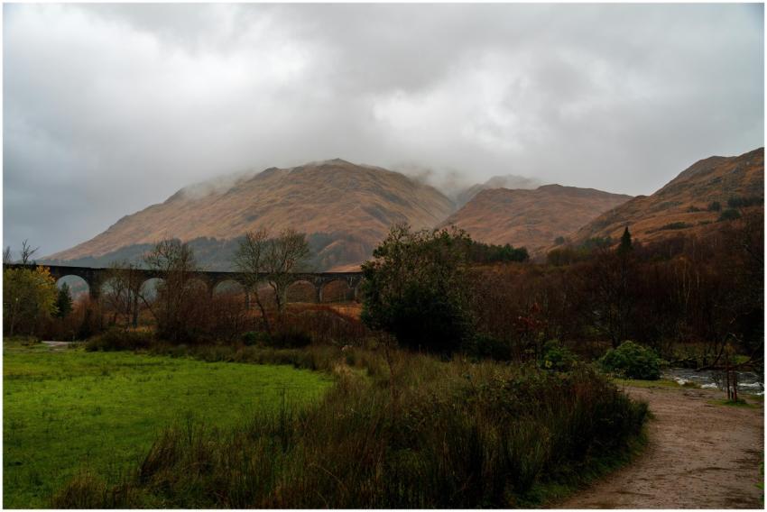 Misty landscape of Glenfinnan Viaduct with lush gr
