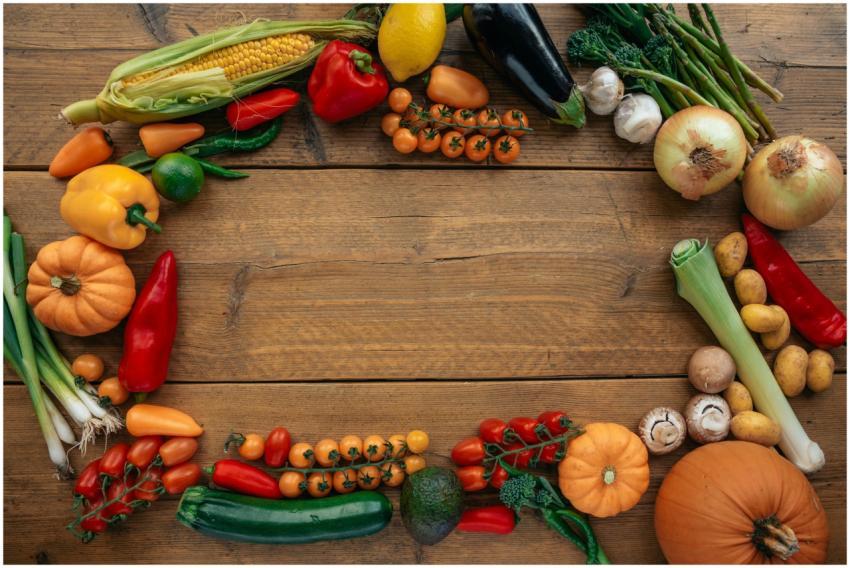 Top view of assorted fresh vegetables forming a fr