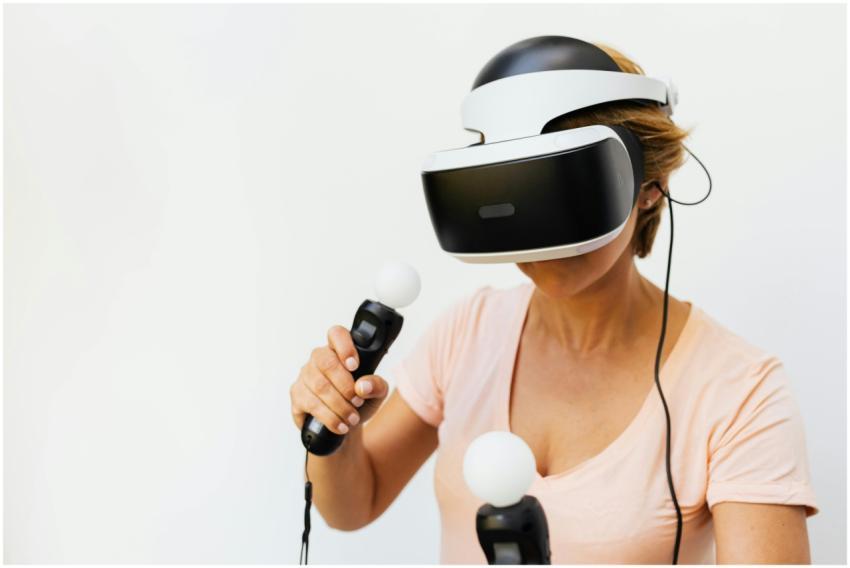 Adult woman gaming with VR headset and controllers
