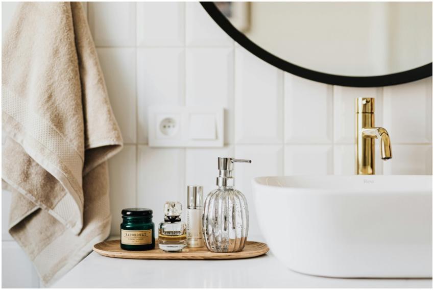 A stylish bathroom sink with skincare products and
