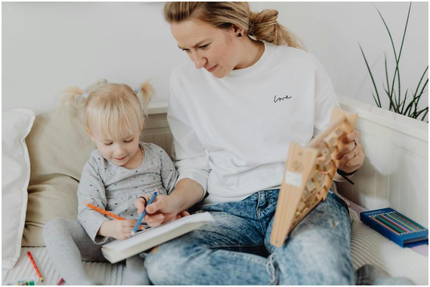 A mother and daughter enjoy drawing together in th