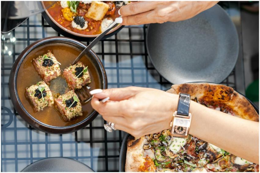 A close-up of a luxurious meal with caviar and piz