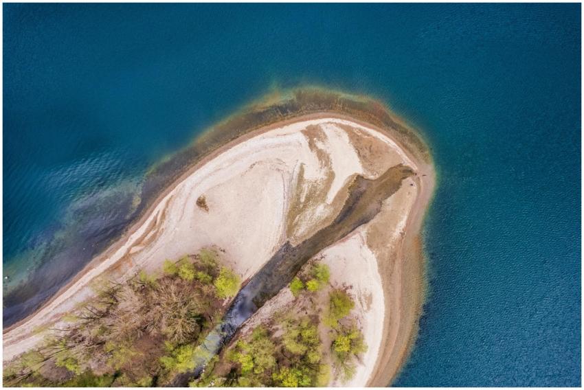 Aerial photograph of a small island with sandy bea