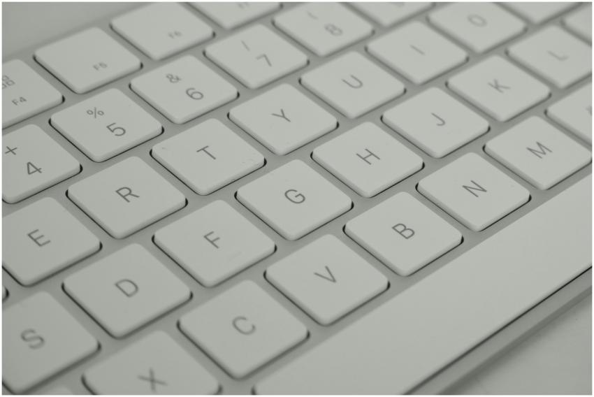 Detailed close-up of a sleek white keyboard, empha