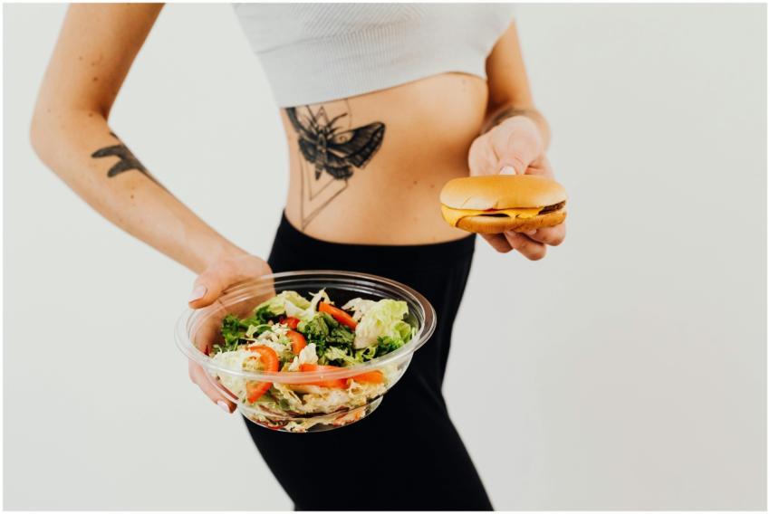A woman with a tattoo holding a healthy vegetable