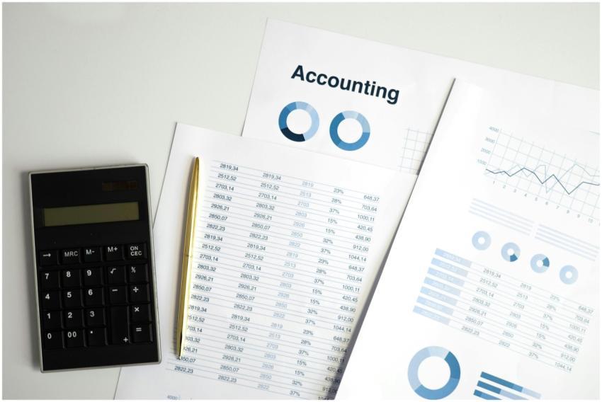 Calculator and accounting documents with charts on