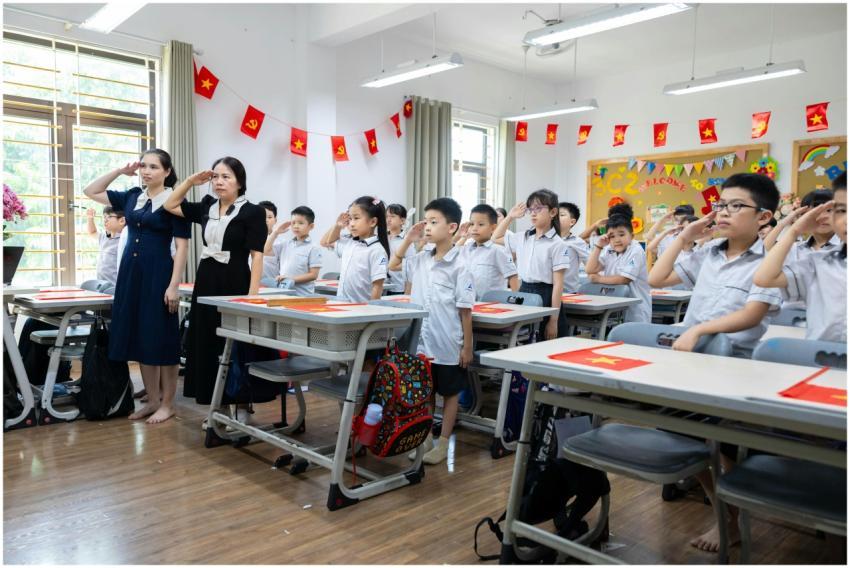 Children and teachers saluting in a colorful class
