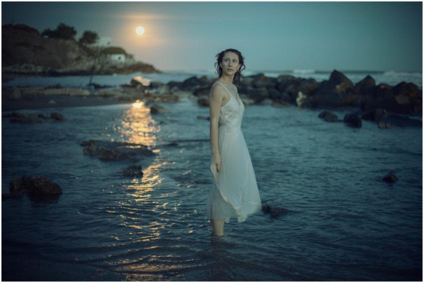 A serene scene of a woman in a white dress standin