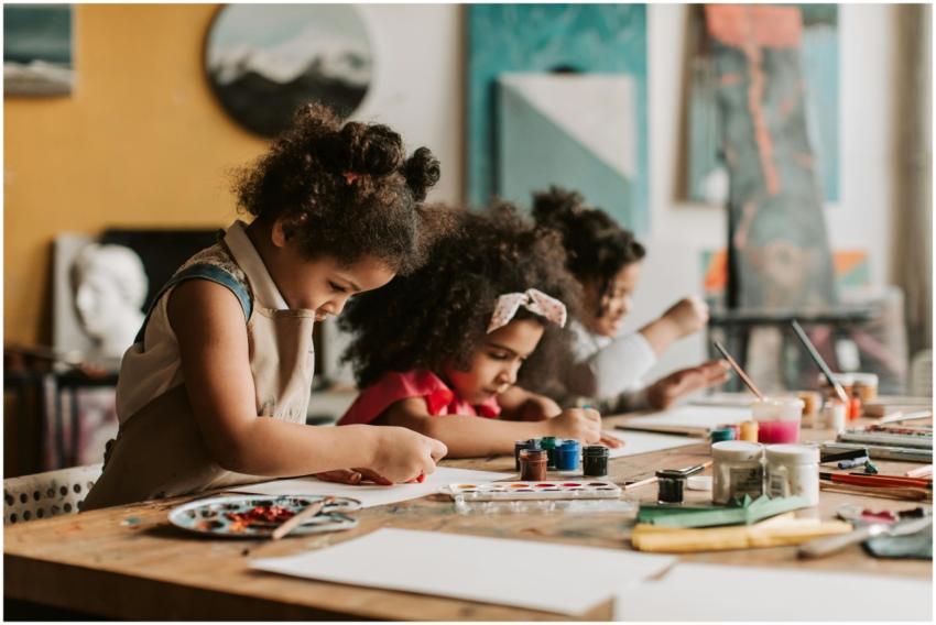 Three young girls expressing creativity in a vibra