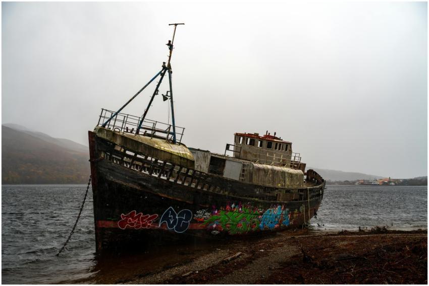Eerie abandoned ship with vibrant graffiti on the