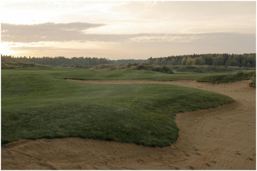 A tranquil golf course landscape at sunset, showca