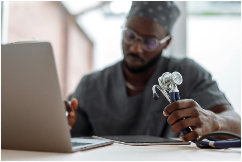 Focused African American doctor in scrubs working