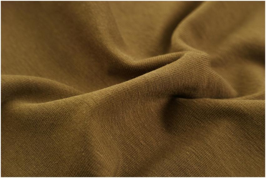 Detailed close-up view of brown fabric with visibl
