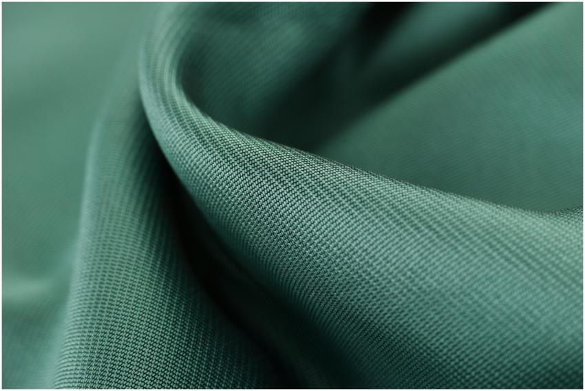 Close-up texture shot of elegant green satin fabri