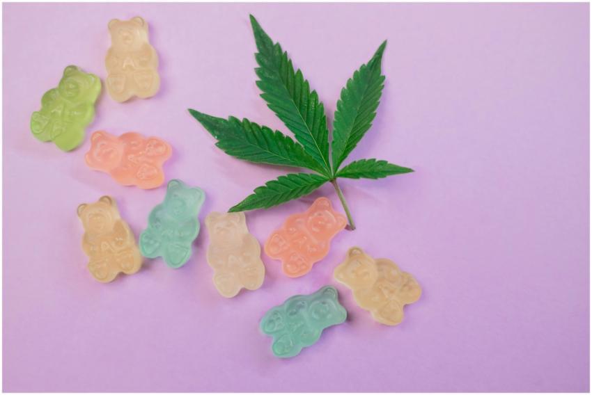 Vibrant gummy bears and a cannabis leaf on a paste