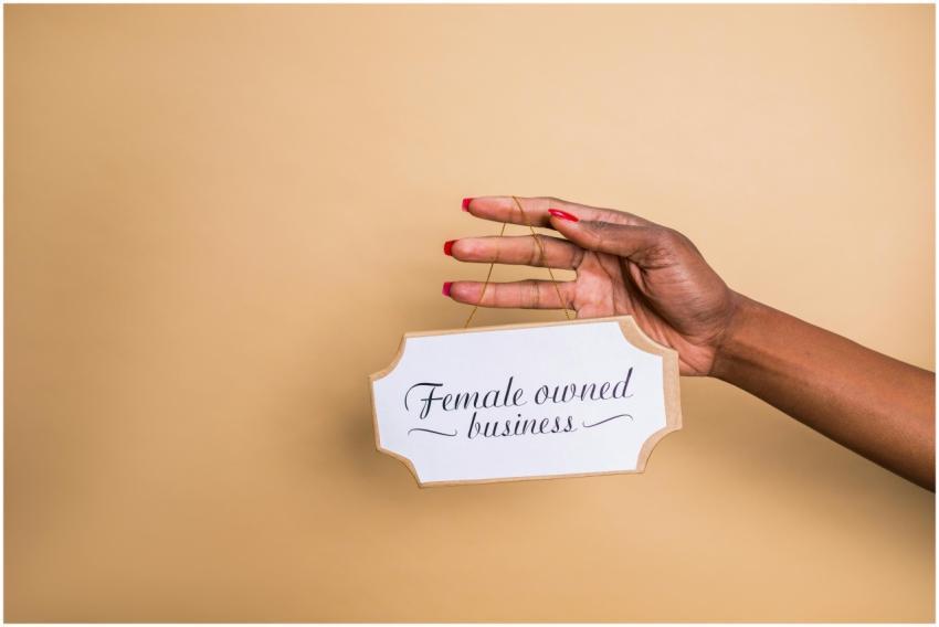 Close-up of a woman's hand holding a 'Female Owned