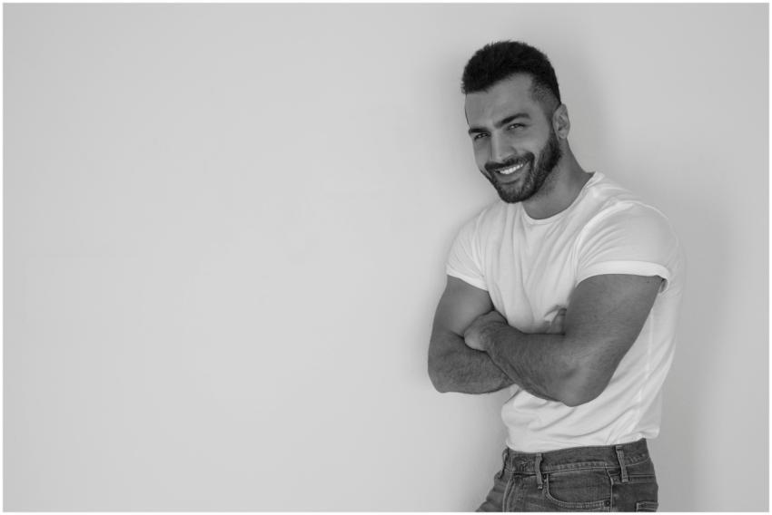 Monochrome portrait of a stylish man with arms cro