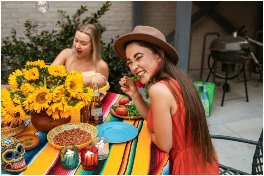 Cheerful women enjoying Mexican cuisine and decora