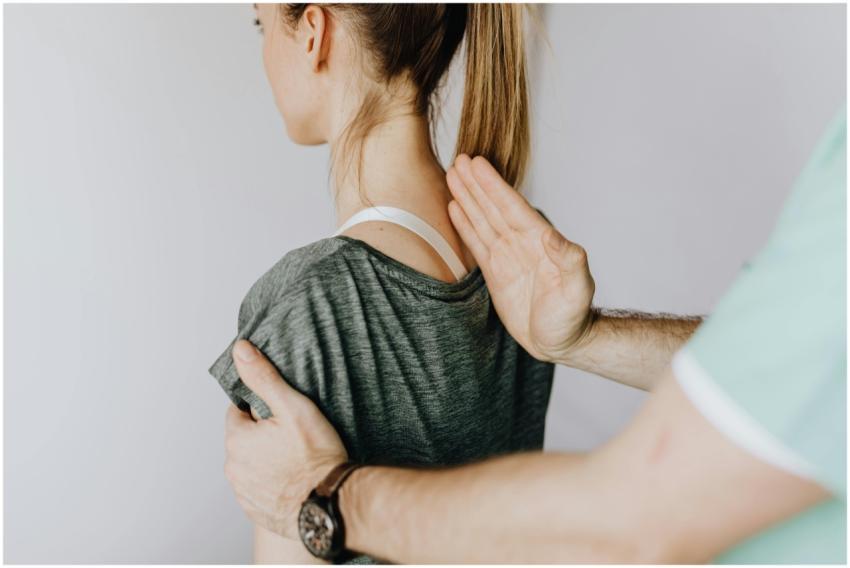 Back view of crop unrecognizable osteopath in unif