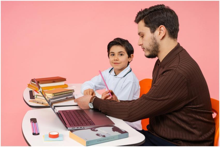 A teacher assists a student in a colorful classroo