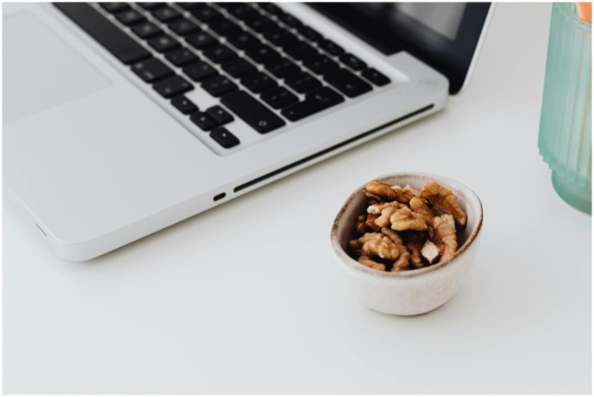 A minimalistic work desk setup featuring a laptop