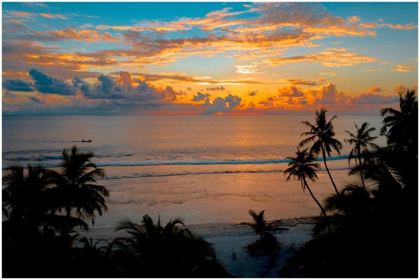 A stunning tropical sunset over a tranquil ocean w