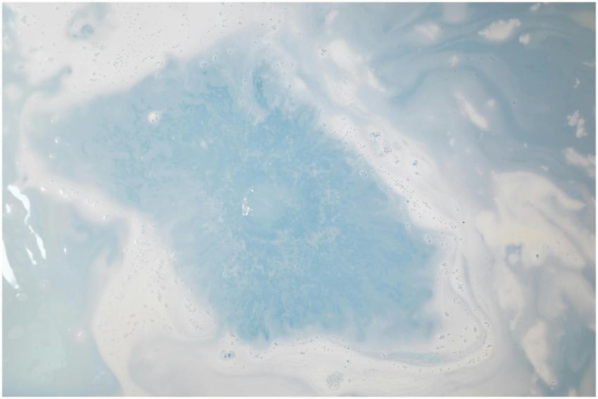 A calming top view of blue and white swirling wate