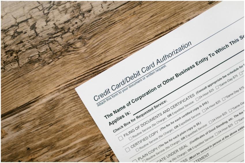 A credit card authorization form placed on a woode