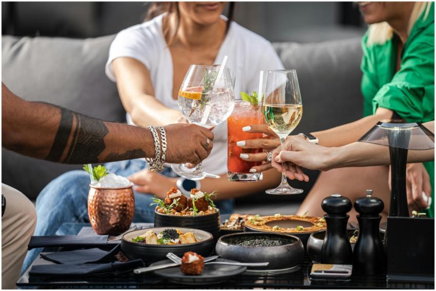 A group of friends enjoying cocktails and snacks a
