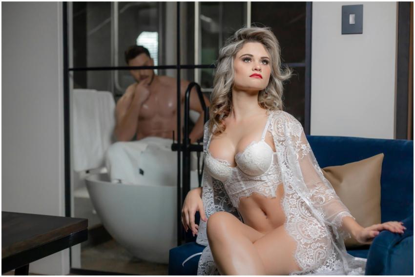 Sophisticated woman in lace lingerie sitting indoo