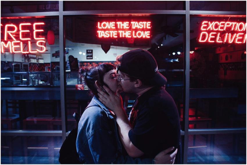 A couple shares a romantic kiss at night under vib