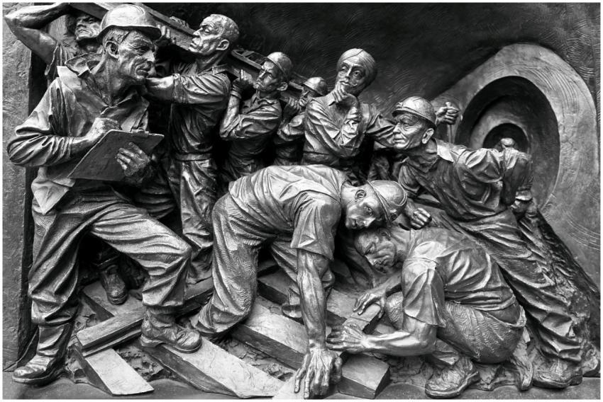 Detailed relief showing a group of miners in actio