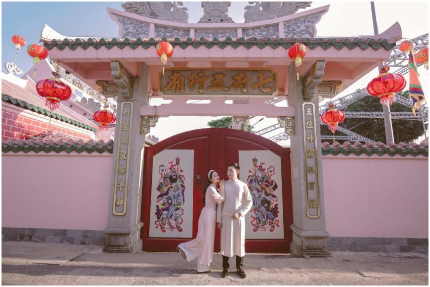 Couple posing romantically in front of a tradition