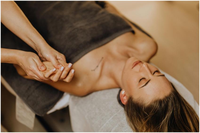 A woman enjoys a relaxing hand massage at a spa, p