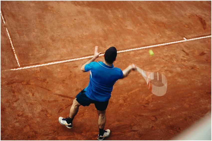 Aerial view of a tennis player serving during a ma