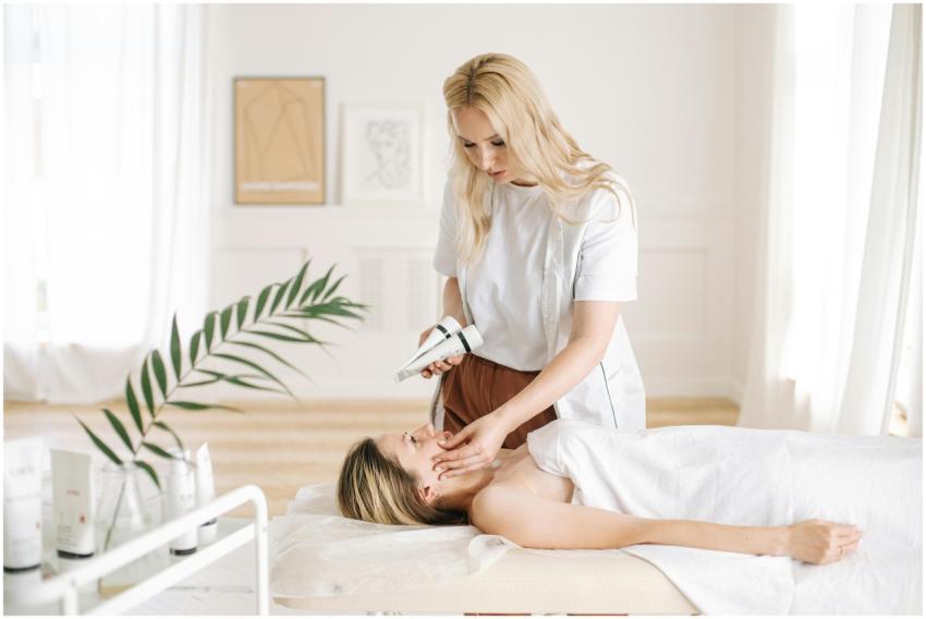 Aesthetician performing a facial treatment on a cl