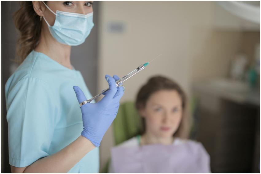 Dentist holding a syringe in clinic, preparing for