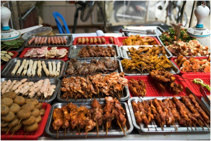 A colorful assortment of grilled street food skewe