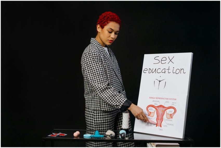 A woman with red hair presenting a sex education s