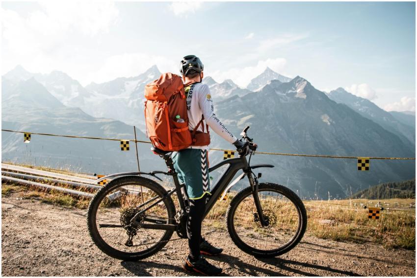 Cyclist with backpack enjoying a scenic mountain v