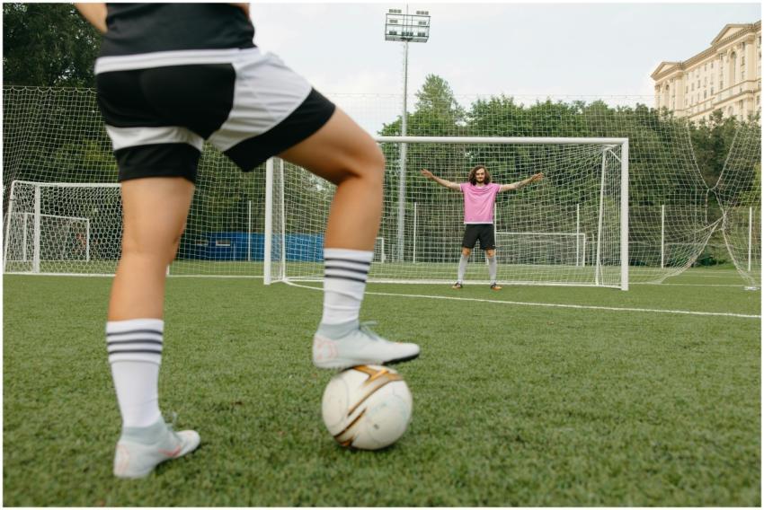 Soccer player in action aiming for the goal with a